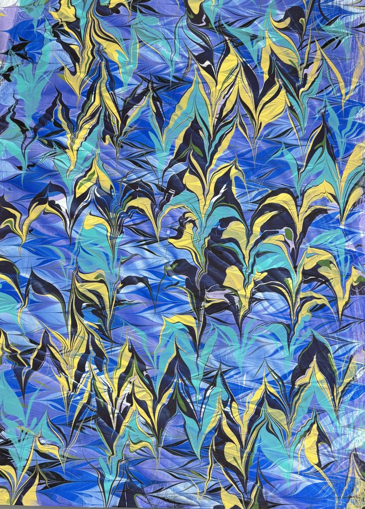 Over-marbled pattern in blue, teal, yellow, black and purple.