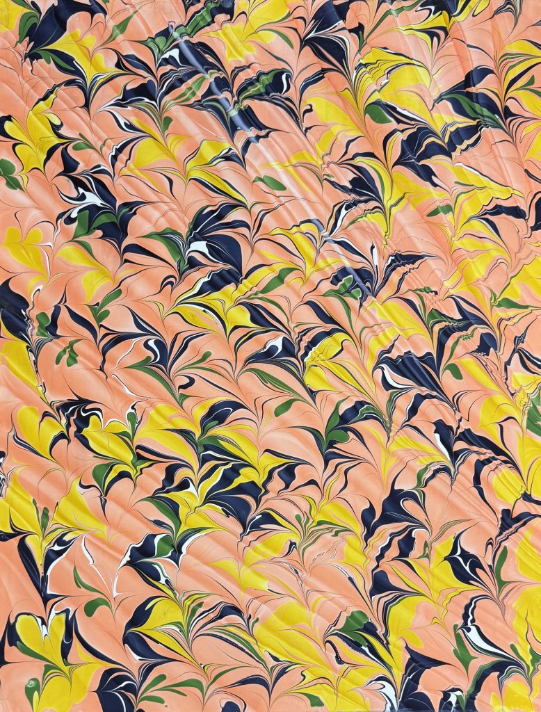 Pattern with Spanish wave in shades of coral, yellow, navy and green.
