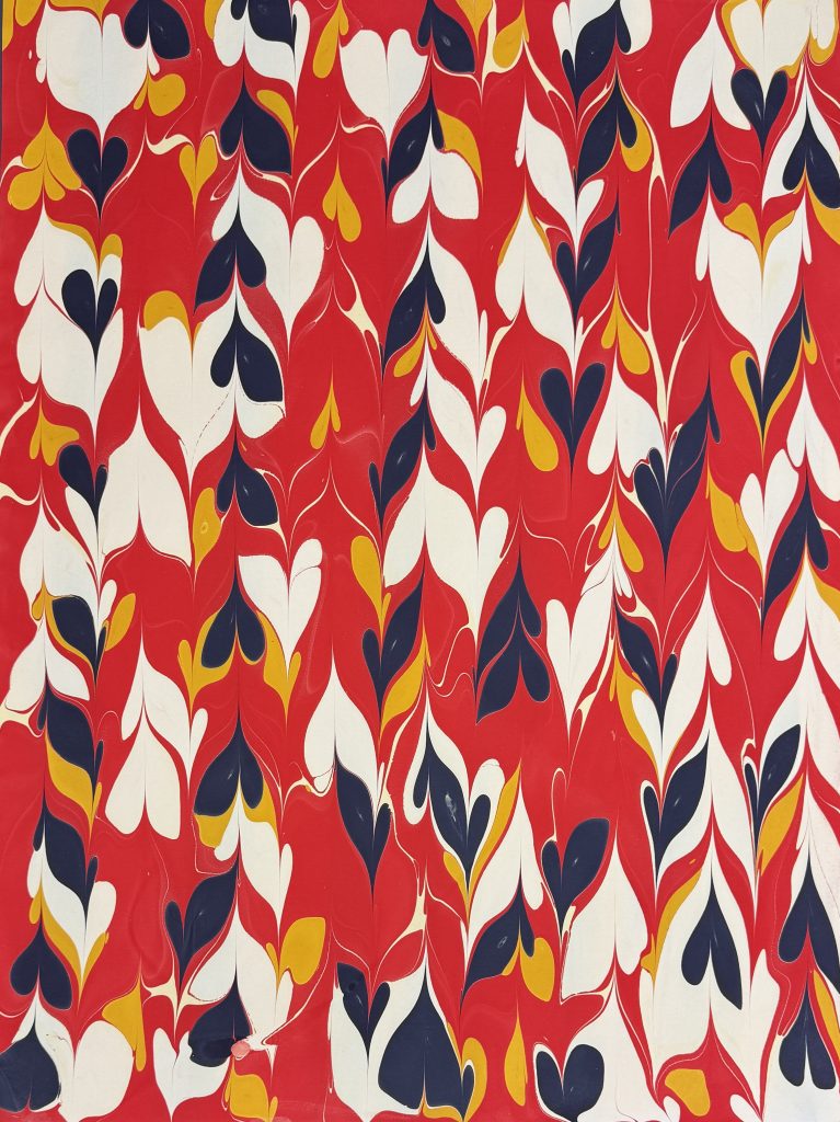 Drawn stone pattern in shades of red, navy, white and yellow.