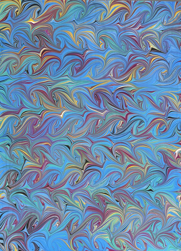 Snail pattern in shades of bright blue, fuchsia, teal, yell and black.