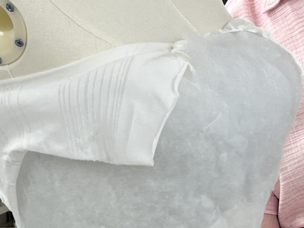 Close up of mannequin bodice with batting and hose covering showing.