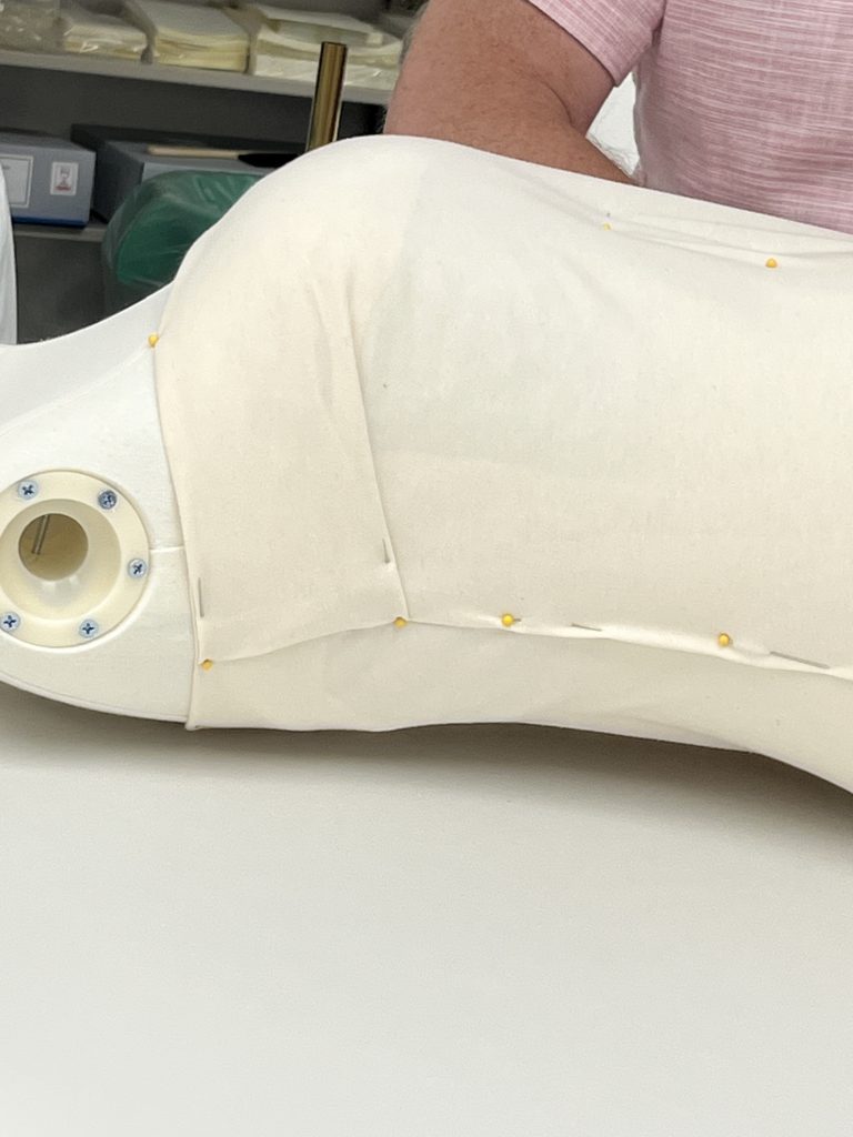 Same mannequin with new layer of cotton jersey covering batting and hose.