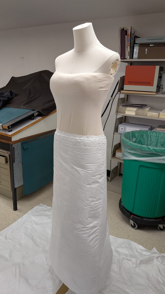 Mannequin with bodice built out and wrapped in jersey cotton and skirt built out with tyvek covered felt.